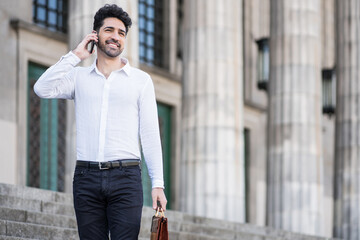 Businessman talking on the phone outdoors