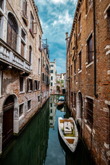 Fototapeta na wymiar Street view of Venecia canal with boats and gondolas. Italy, Venice.