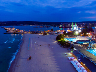 View from above of the port and beach in night Varna in Bulgaria. Summer holiday in Europe. Aerial photography, drone view.