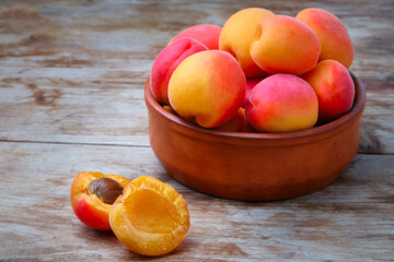 Fototapeta na wymiar Heap of ripe juicy apricots on a table. Rustic style. Crop of apricots