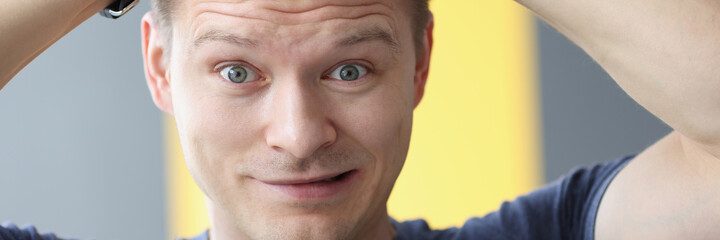 Portrait of an upset man holding his hair with his hands