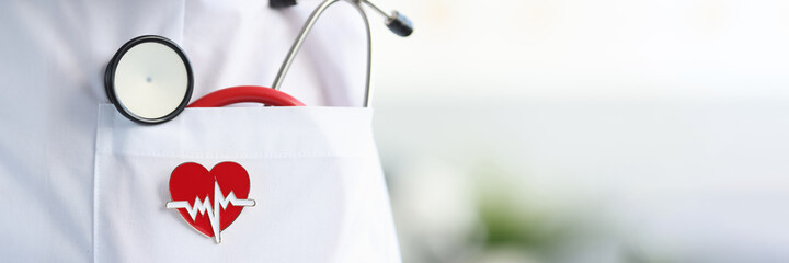 Stethoscope and heart icon lie in white doctor's coat