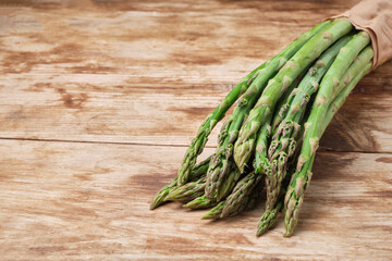 Bunch of a green asparagus on weathered wooden table rustic style with copy space
