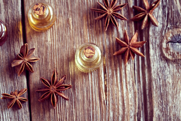 A bottle of star anise essential oil with star anise. Aromatherapy or natural medicine.