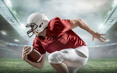 American football sportsman player with ball in action on stadium under lights of background. Sport, proud footballer in white helmet and red t-shirt ready to play.