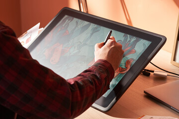 Unrecognizable designer drawing on graphic tablet