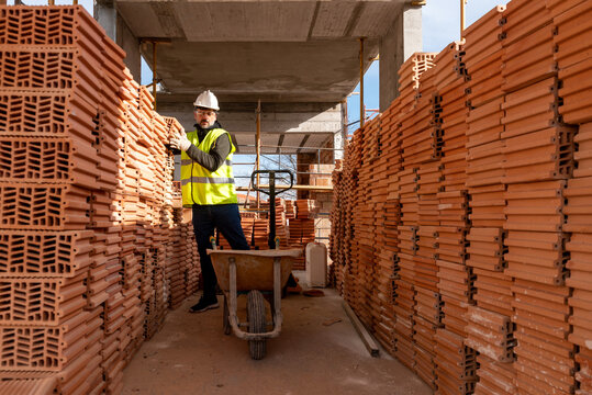 Builder loading cart with bricks