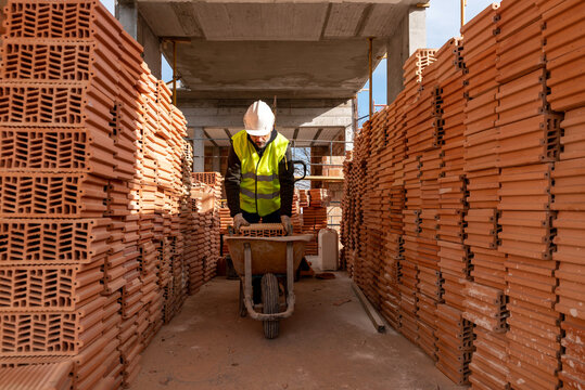 Builder loading cart with bricks