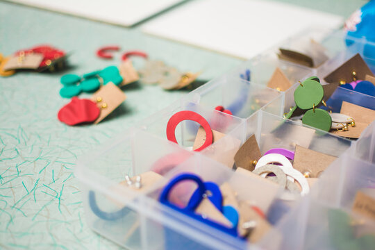 Jewelry pieces made of clay lying on work table