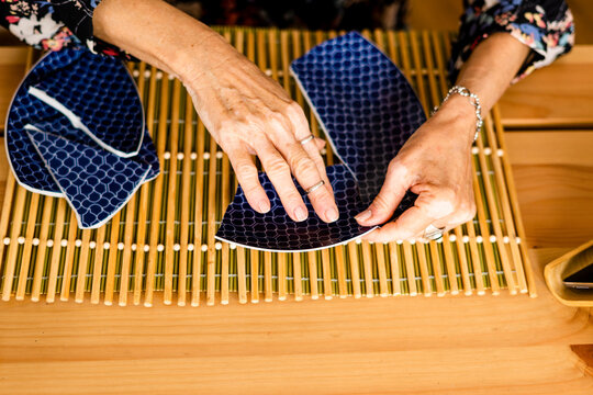 Close-up of woman picking up a broken plate 