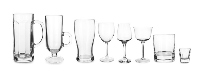 Different empty glasses on white background