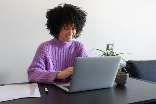 Woman Smiling In Front Of Laptop