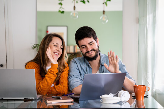 Young couple doing videocall with friends and family from home