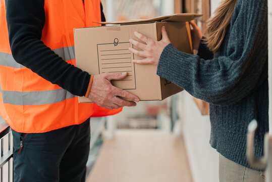 Delivery man with mask delivers package to customer.