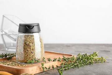 Composition with dried herbs and fresh thyme on table