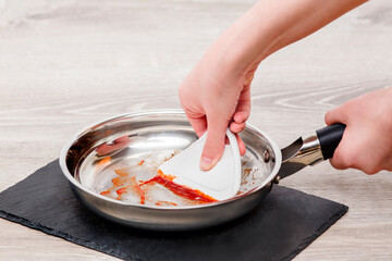 Hand scooping on cooking pan