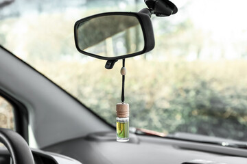 Air freshener hanging in car, closeup