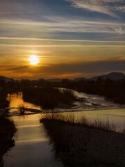Winter sunset with mist over River Serchio near the city of Lucca