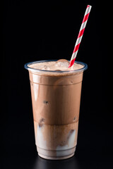 Iced dark chocolate drink in plastic cup with straw