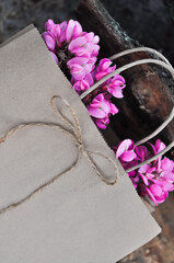 disposable paper craft eco bag with pink acacia flowers, zero waste concept