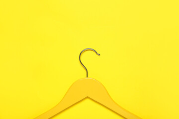 Stylish clothes hanger on color background