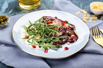 Plate with delicious beetroot carpaccio on table
