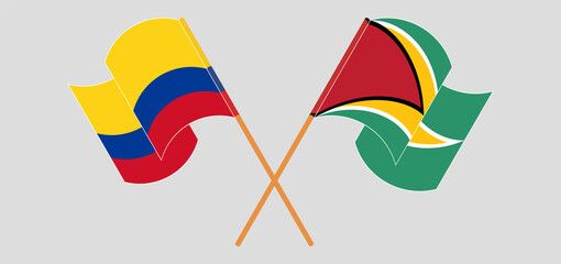 Crossed and waving flags of Colombia and Guyana