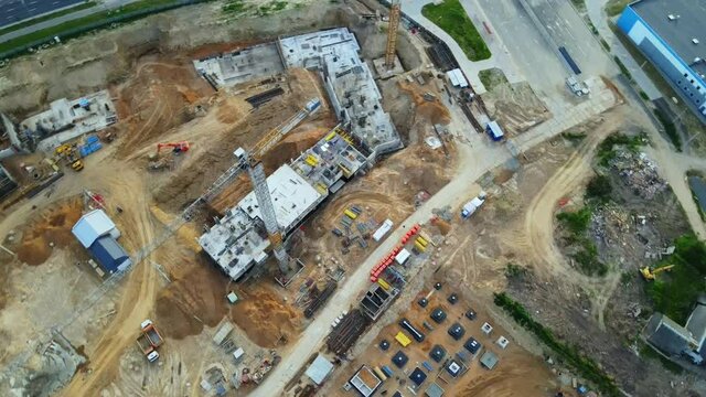 Aerial view of the new urban development. New houses are being built. Flight in a circle around the block under construction. The cranes are visible. Fly with the camera down