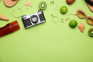 Set of beach accessories and fruits on color background