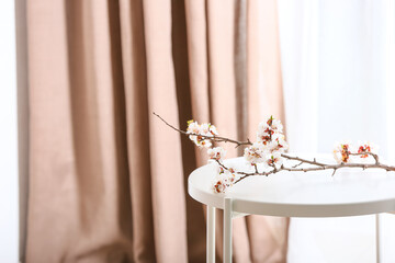 Beautiful blooming branch on table in room