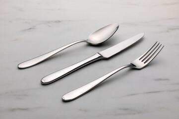 Steel cutlery on the white marble table.