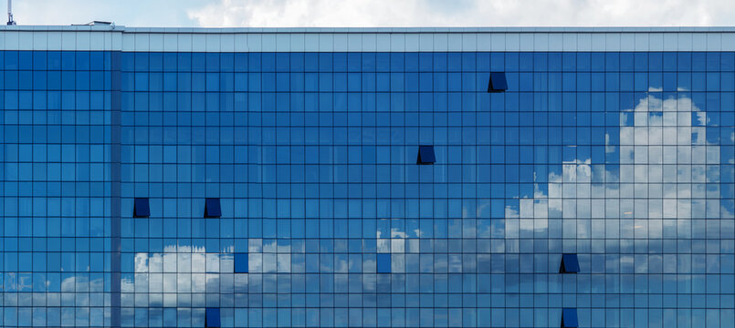 reflections of clouds in office windows