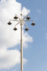Street lamp with lamps in a classic style against a blue sky. High quality photo