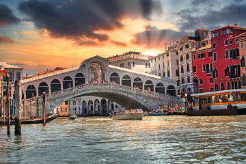 Rialto bridge in Venice with gondolas at sunset in Venice 