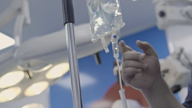 Closeup of IV drip in hospital.   medicine or antibiotic therapy and surgery recovery in a hospital or clinic