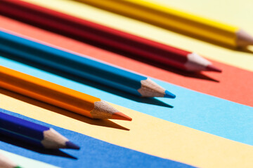Color pencils on colored background. Back to school, arrangement concept.
