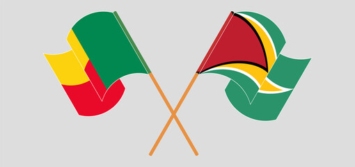 Crossed and waving flags of Benin and Guyana