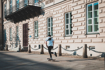 man riding a skateboard in casual clothes, streets of the city