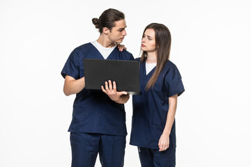 The young doctor and his assistant at work with laptop isolated on white background