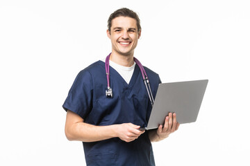 Naklejka na ściany i meble Young doctor with stethoscope working on a laptop against white background