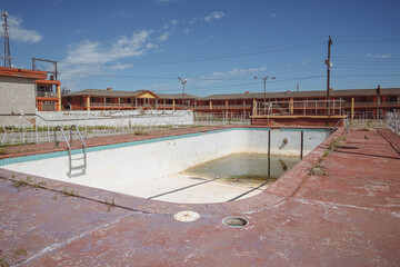 Dirty abandoned outdoor swimming pool at a motel, now abandoned, along the historic US route 66