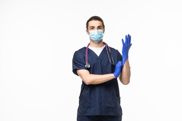 Doctor puts on gloves and wearing medical mask isolated on white background. Medical concept corona virus