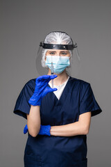Photo of beautiful medic prepare syringe dose patient vaccine injection treatment wear mask coat facial plastic shield surgical cap isolated grey color background