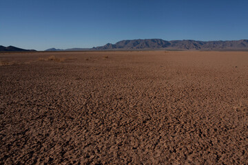 Fototapeta na wymiar A barren desert landscape with distant mountains