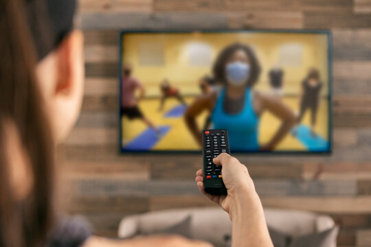 Home: Woman Uses Remote To Set Up Livestream Workout Class