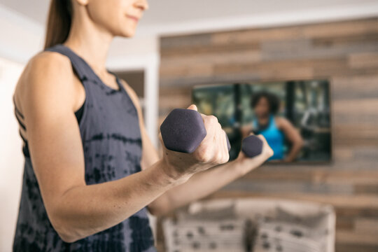 Home: Woman Weight Trains With Remote Streamed Class
