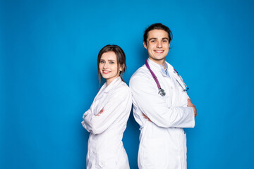 A medical team of doctors, man and woman, isolated on blue background