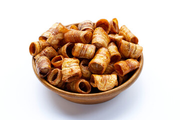 Dried banana rolled chips on white.