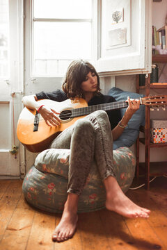 Girl playing some chords with the guitar