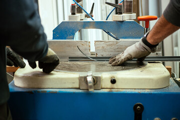 Crop male workers cutting metal in workshop